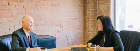 man and woman talking inside office